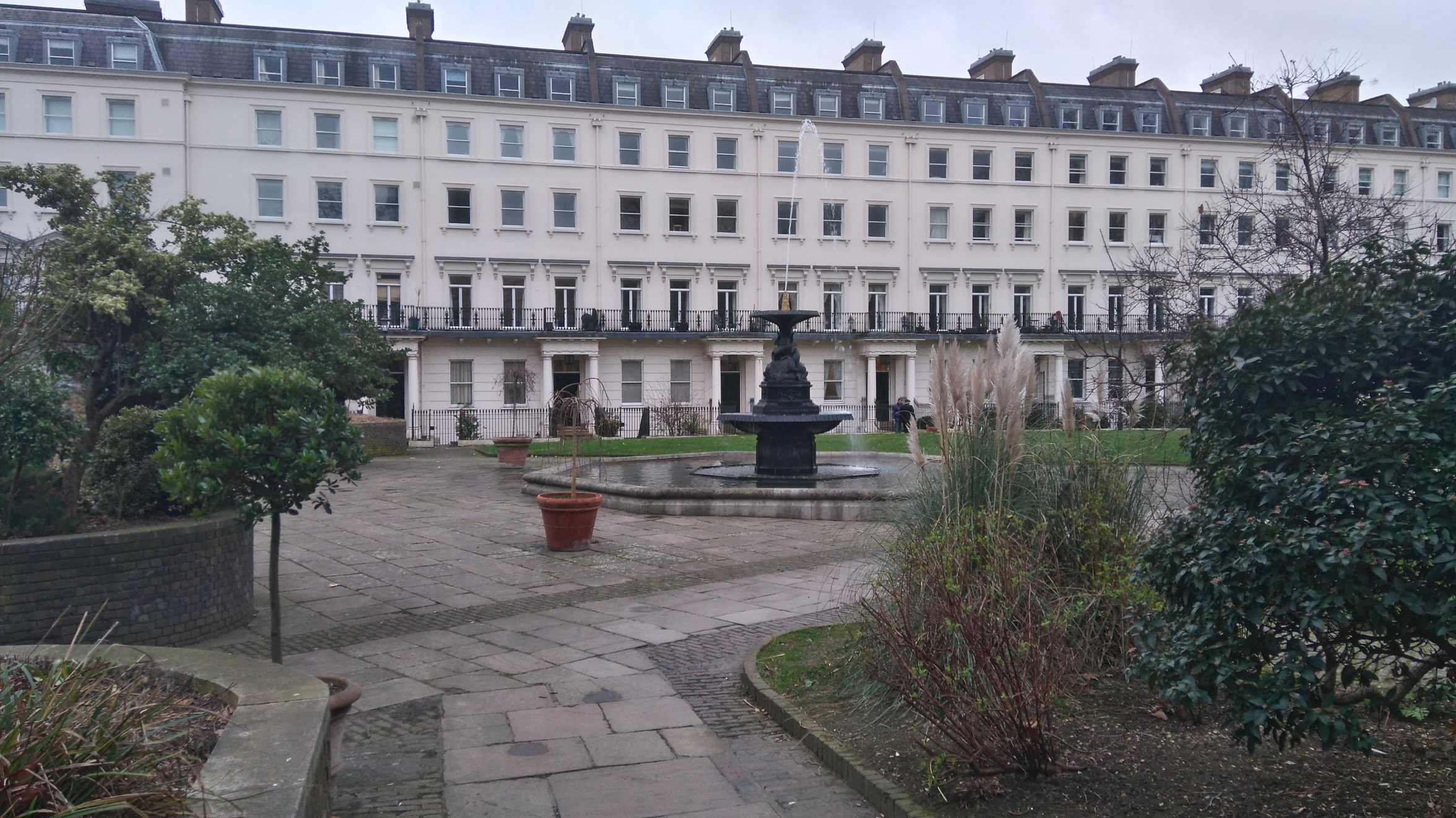 Houses and fountain at Bessborough Gardens in Pimlico viewed from Vauxhall Bridge Road in London