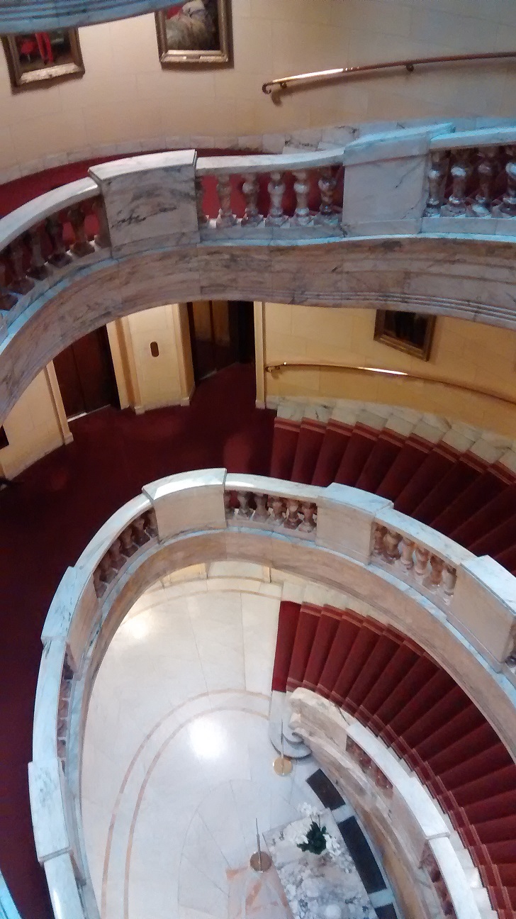 Hotel stairs marble red carpet brass banister