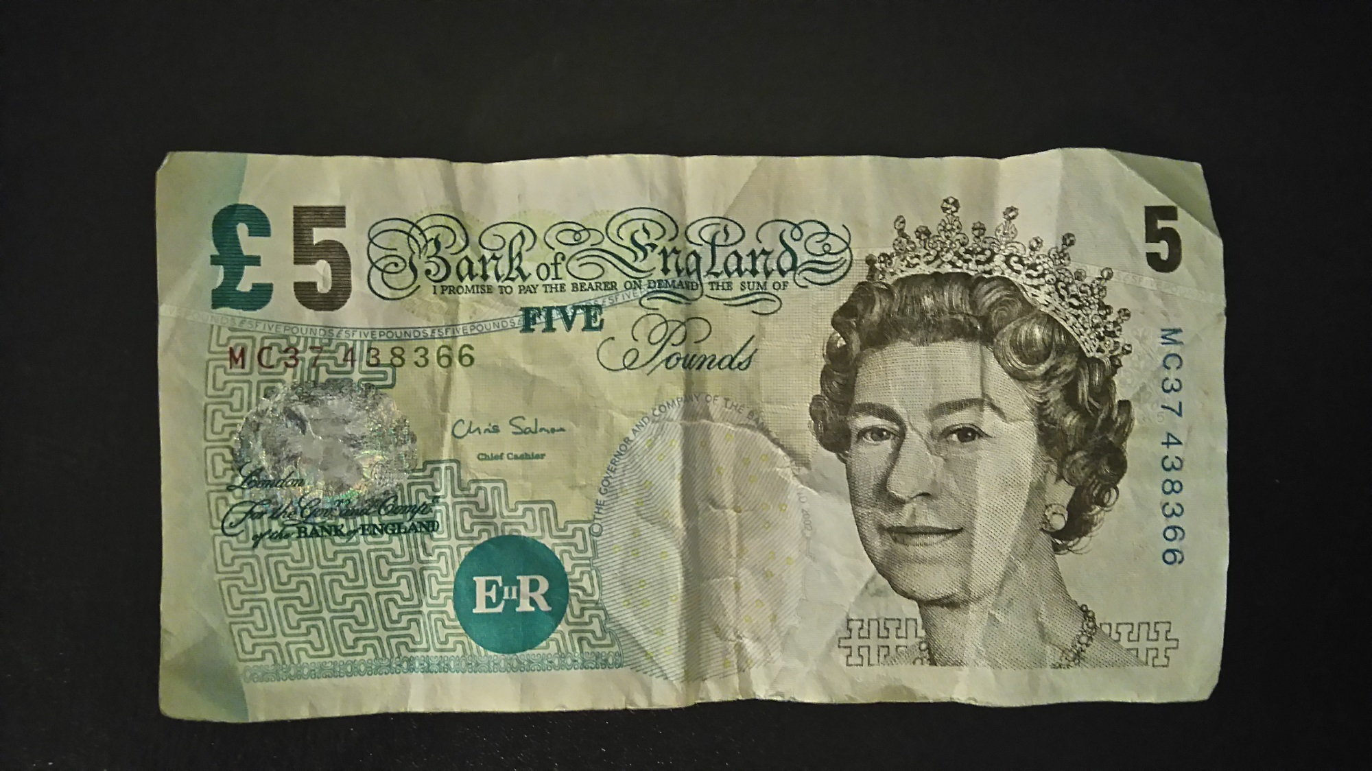 An old Bank of England Five Pound Note viewed from the front.