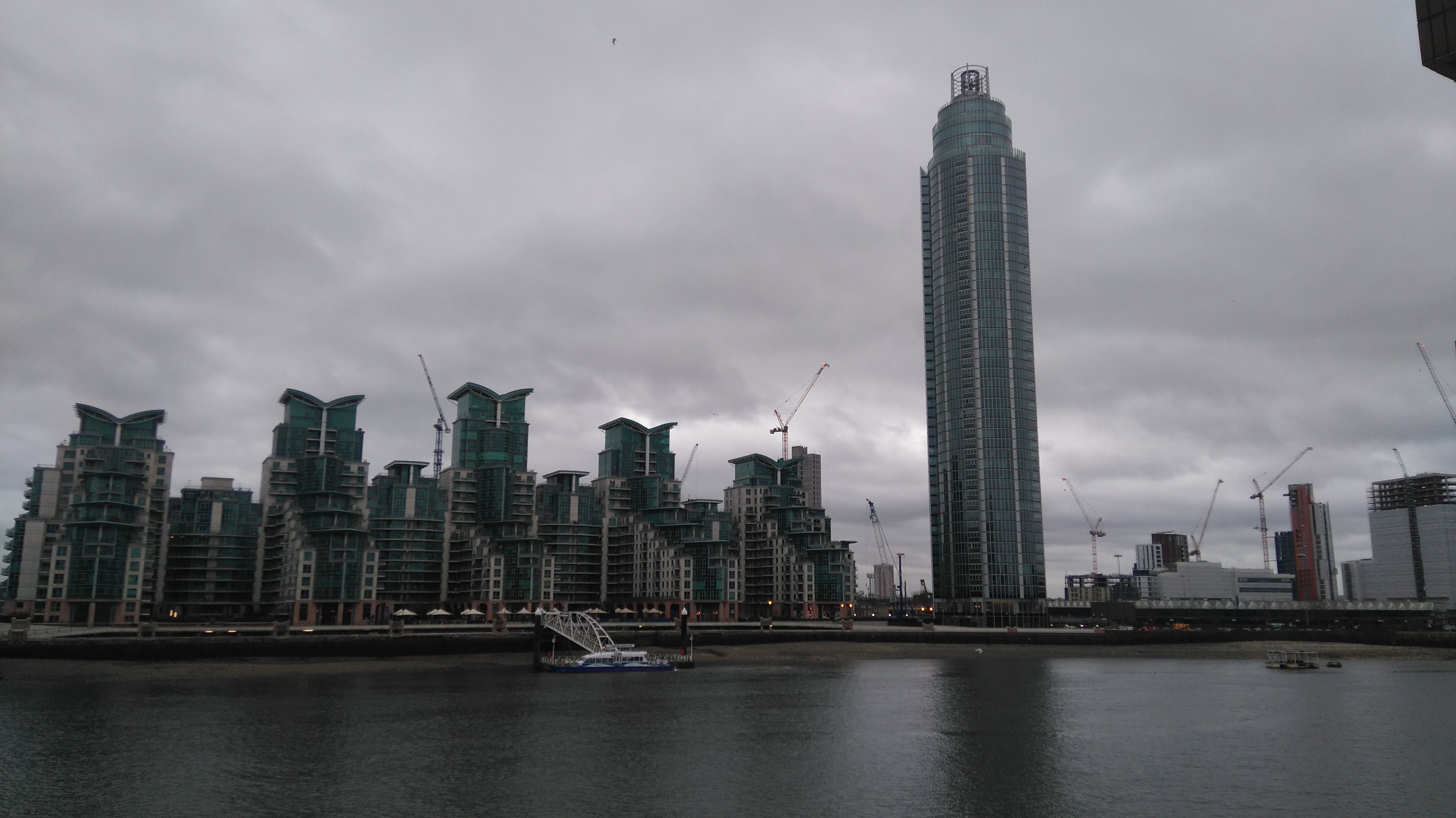 The Tower and Kestrel House buildings viewed from the north side of the river Thames in London on a cloudy day
