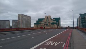 Vauxhall Bridge over the Thames in London viewed facing south towards MI6 headquarters on a cloudy day.