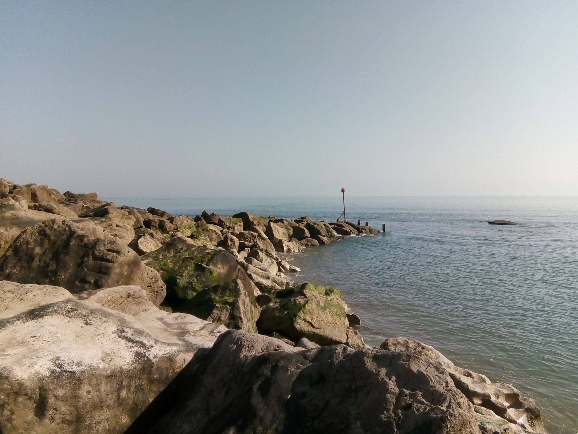 Sea large rocks groyne sunny